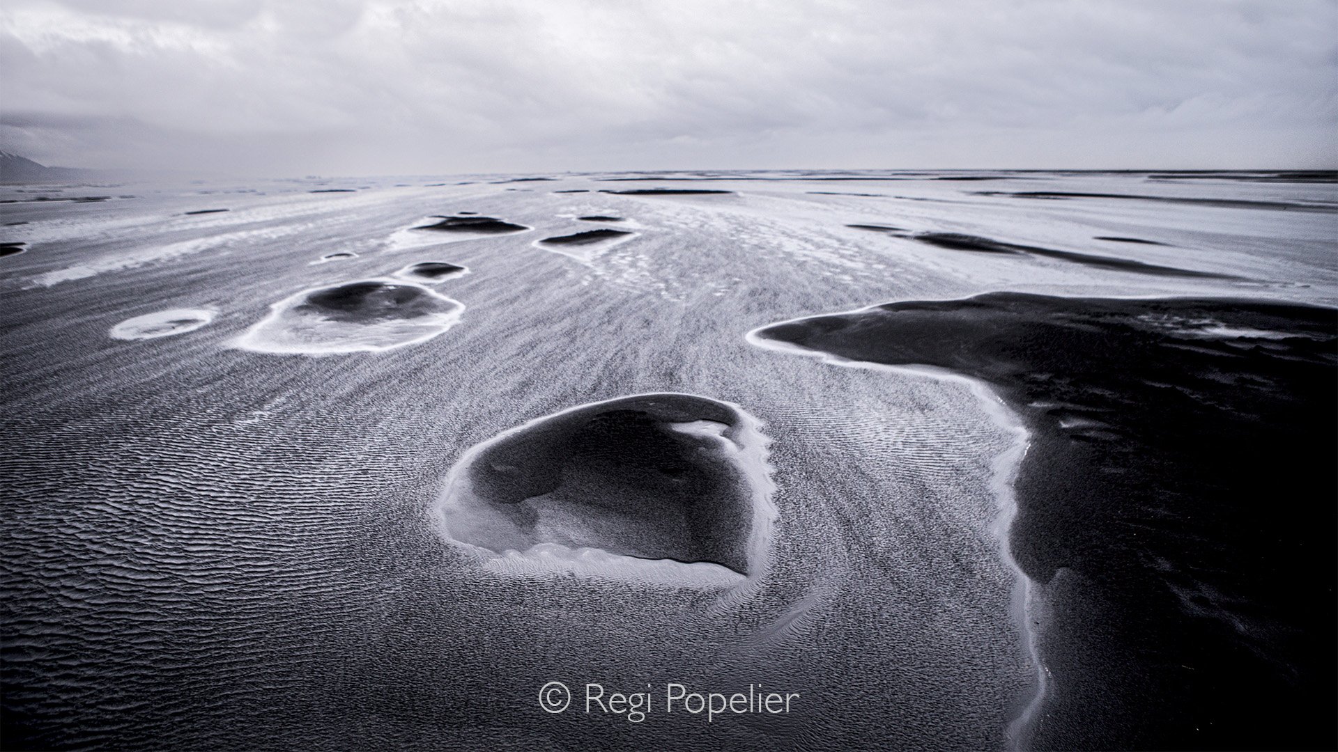 ICEL005 - A layer of water washing the coast line as it withdraws. image taken with slow shutter speed.   