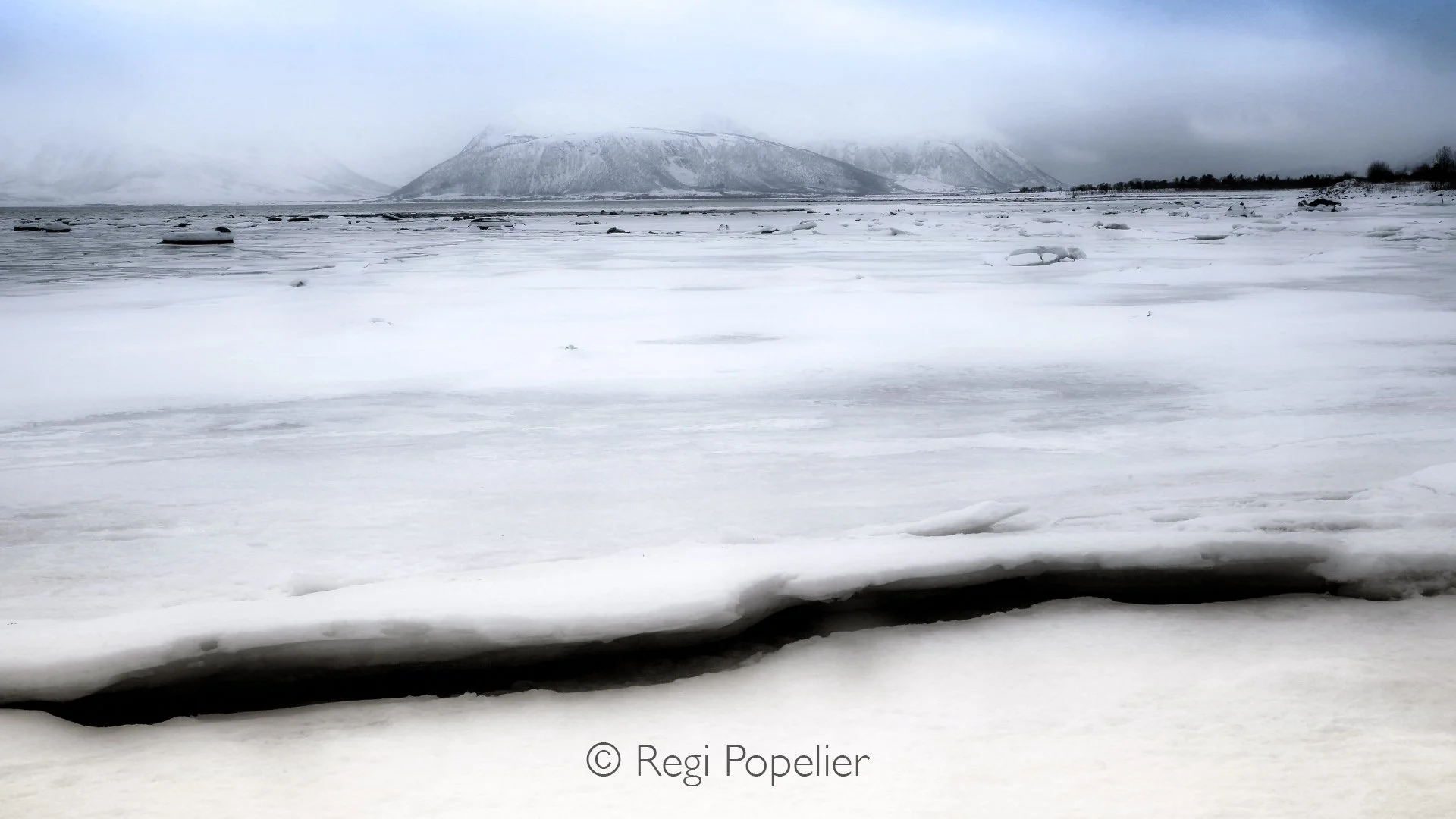 NORWAY011 - Meltwater traces its way through the ice, bringing movement to an otherwise frozen world.