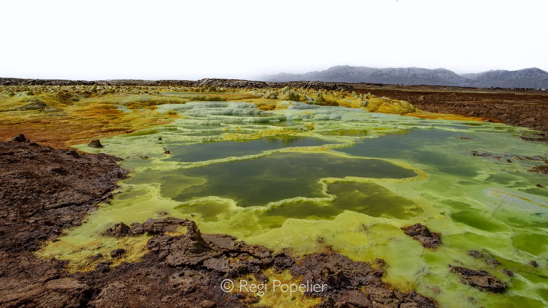 ETH038 - The Danakil Depression—one of the harshest and most dangerous places on Earth. The year previous to my visit five tourists had been killed there.  A permit was required  and had four armed soldiers as guides, I was allowed only two hours in 