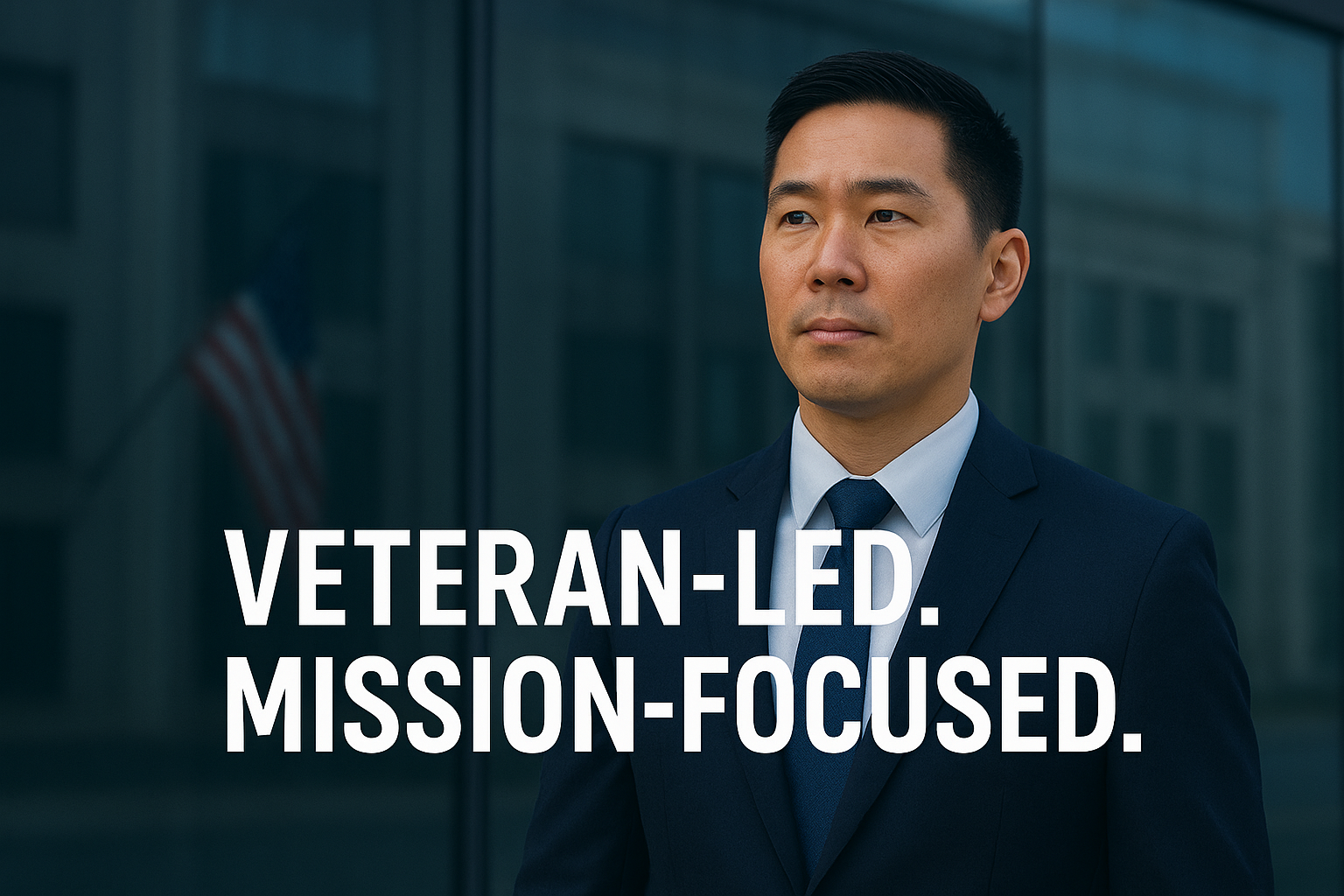 A man in a navy blue suit standing in front of a glass building with an American flag visible through the glass. Overlaid text reads 'Veteran-led. Mission-focused.'