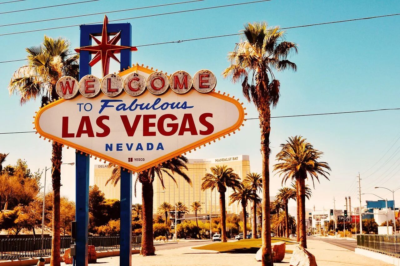 The famous Welcome to Fabulous Las Vegas sign in Las Vegas, Nevada, outdoors with palm trees and clear sky.