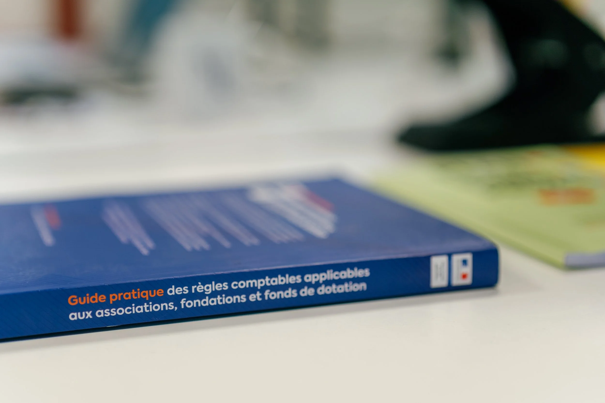 Livre intitulé 'Guide pratique des règles comptables applicables aux associations, fondations et fonds de dotation' sur une table