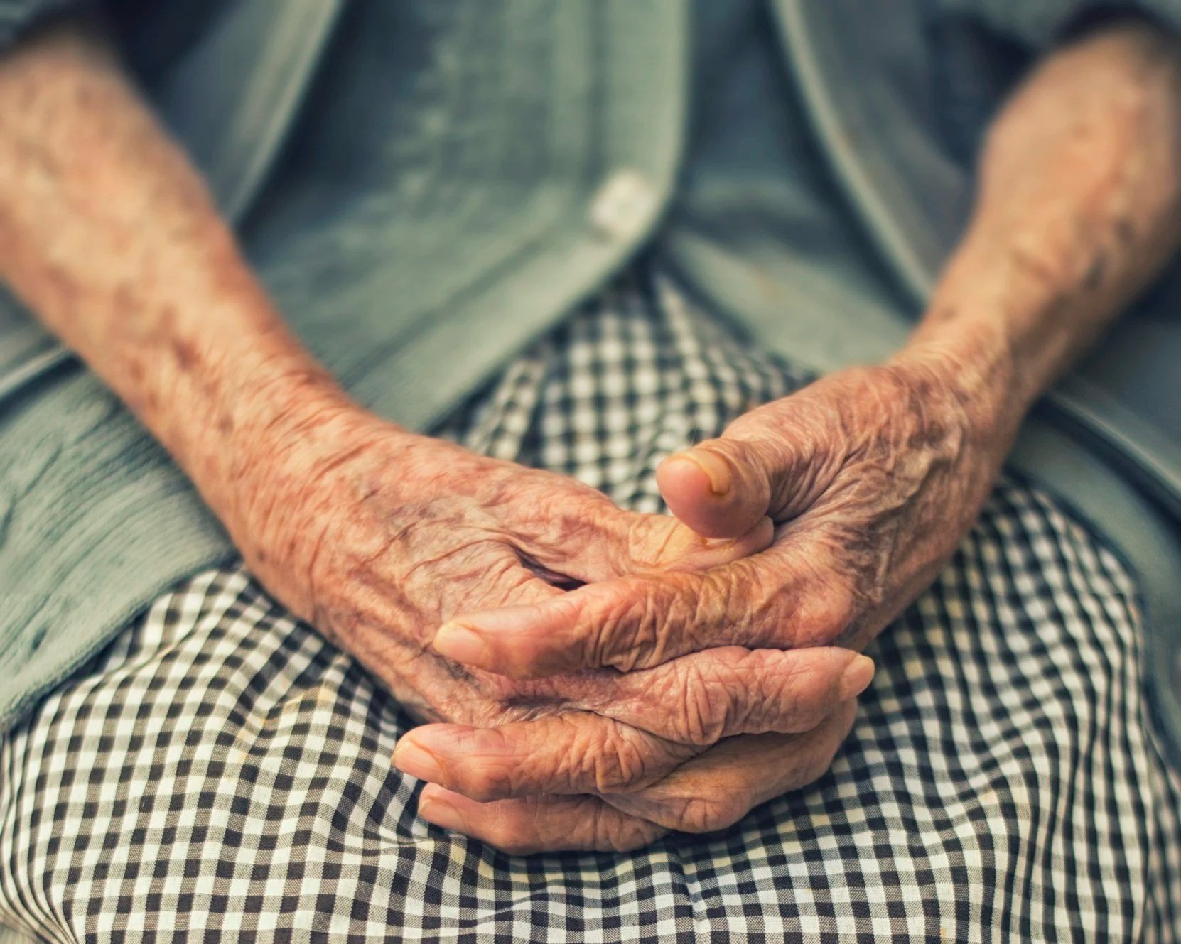 older woman hands on lap, seniors transition and relocation services new hampshire