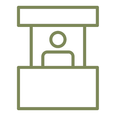 Outline drawing of a person sitting at a booth or counter inside a structure, possibly a small storefront or kiosk.