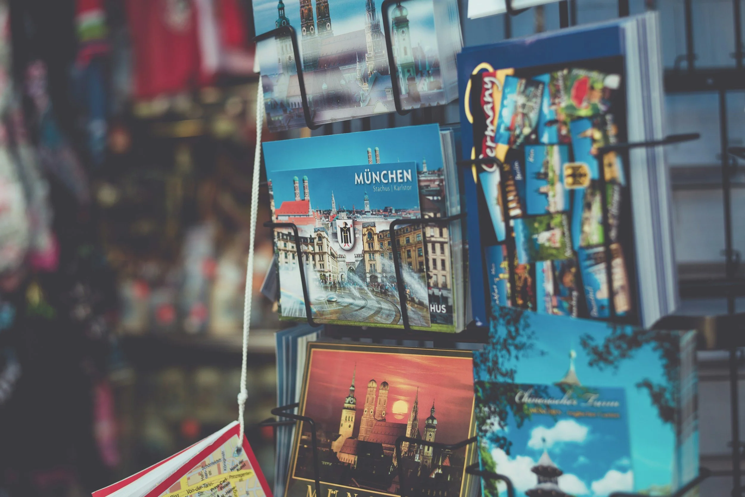 A display of postcards featuring photos and illustrations of Munich, Germany, including landmarks and cityscapes.