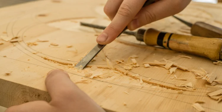 SheShed participant carving timber as part of a creative workshop project