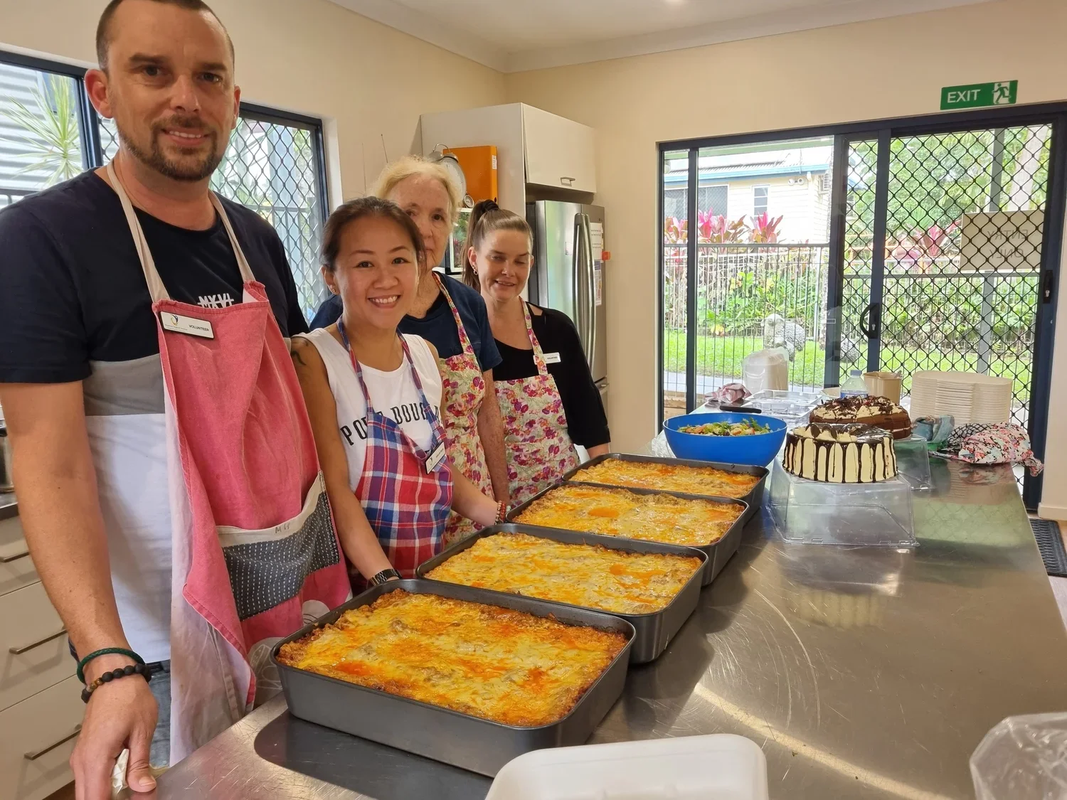 Happy volunteers smiling in the Mossman Community Kitchen