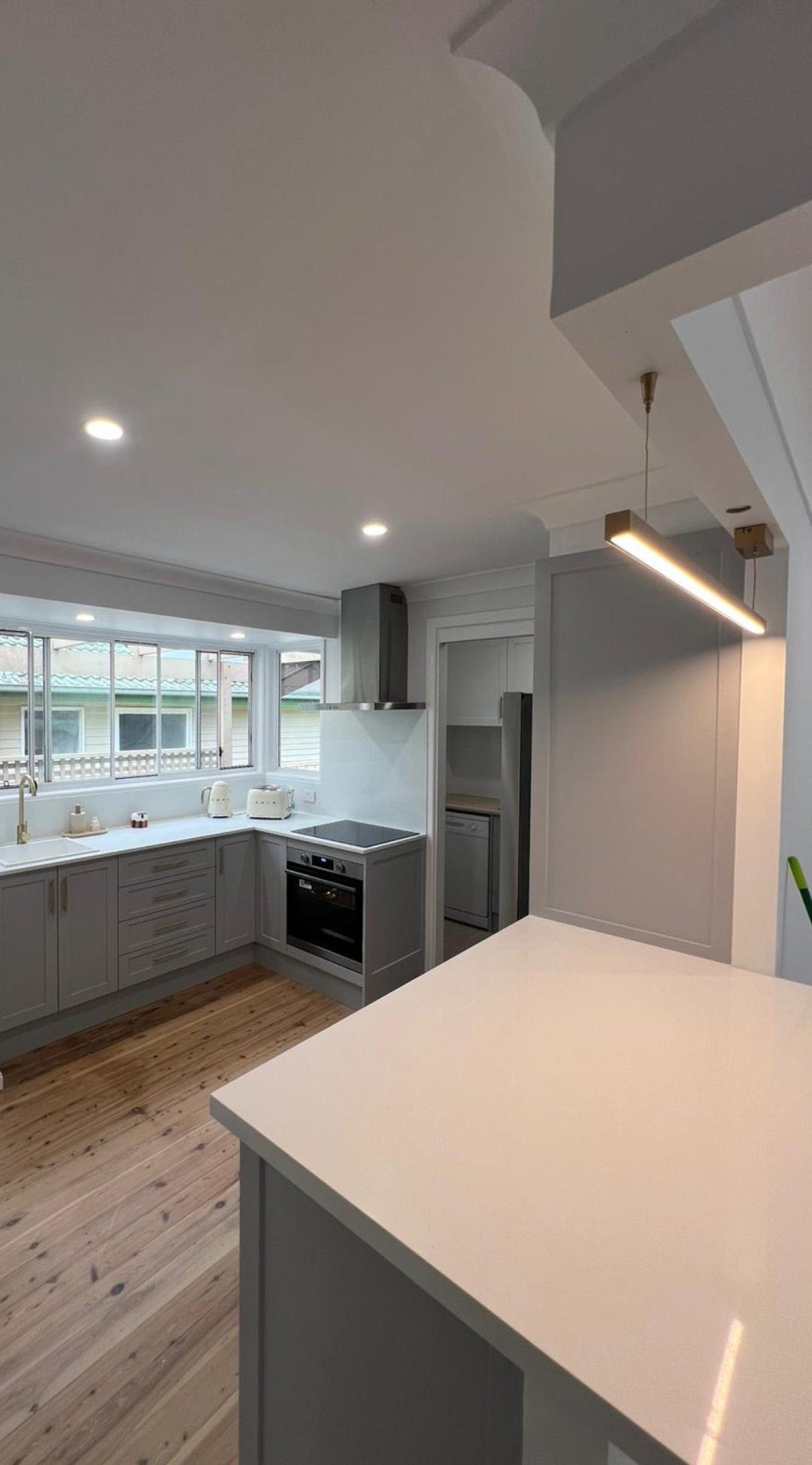 Contemporary kitchen design featuring natural light, neutral tones, and integrated appliances — part of Zamps Electrical's residential project.