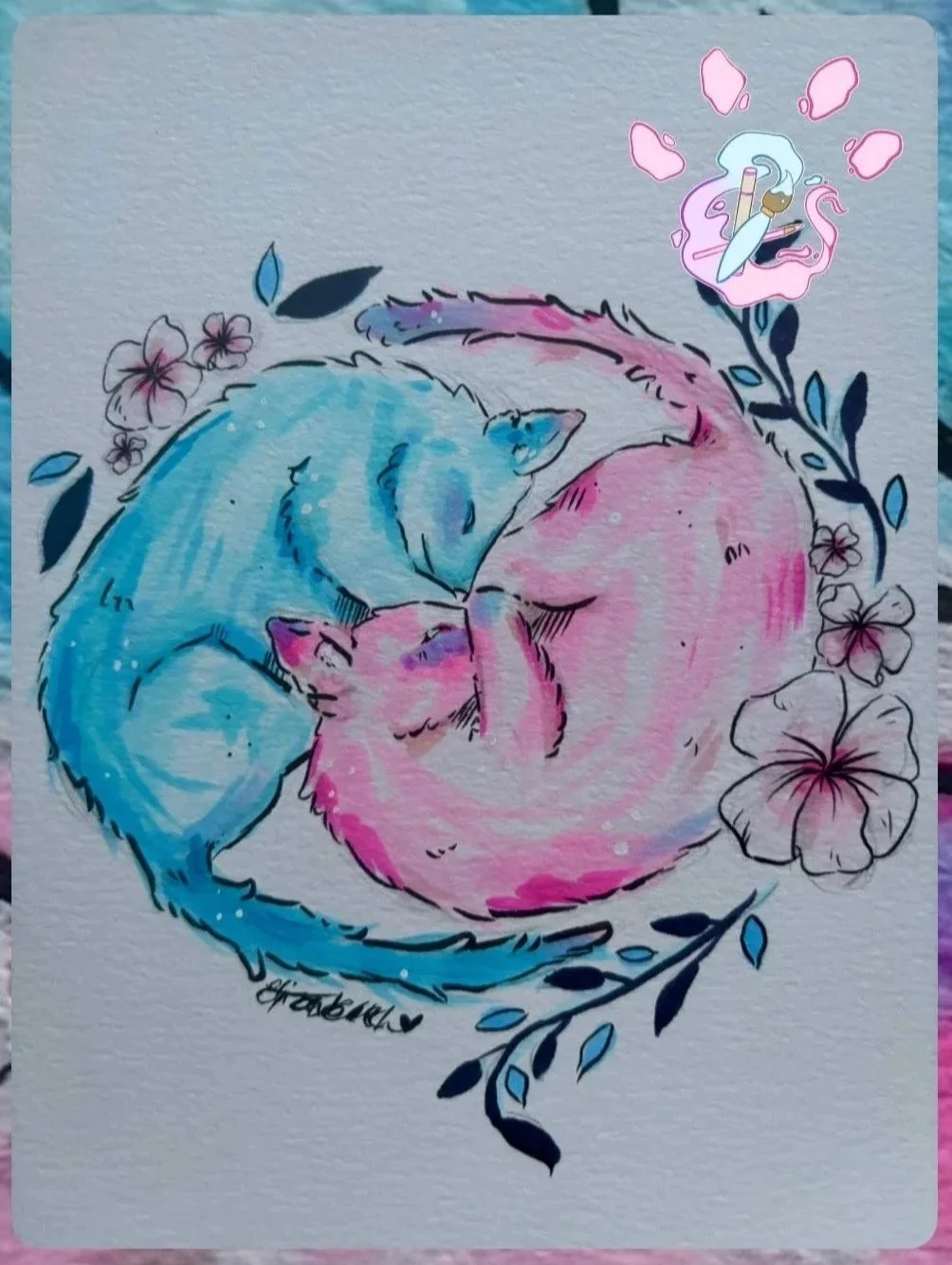 Watercolor painting of two cats, one blue and one pink, curled up together with their heads touching, surrounded by flowers and leaves, with a pink flower in the top right corner containing a paintbrush and palette.