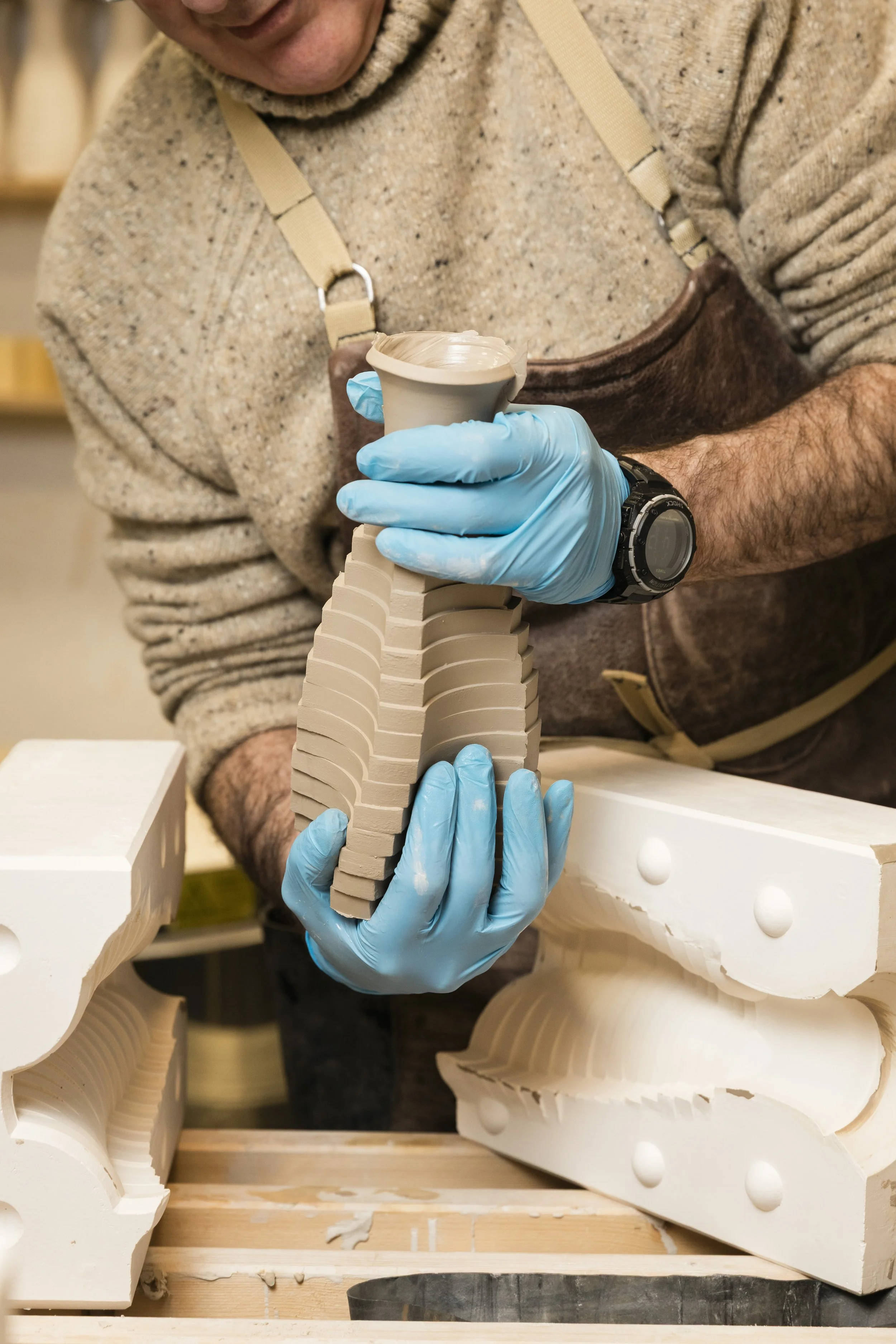 	
Scottish ceramicist, Arra Fletcher, de-moulding in his studio.