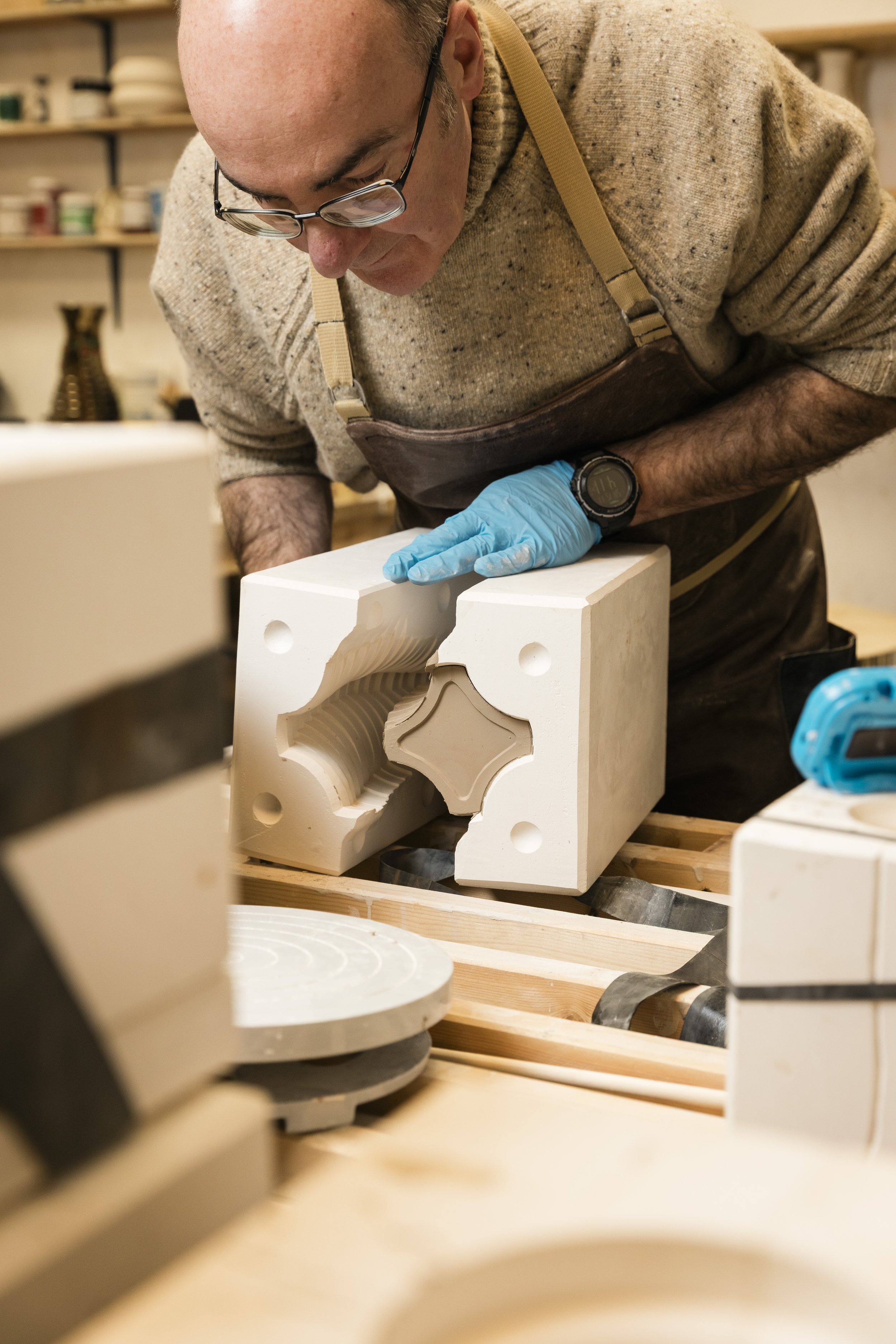 Scottish ceramics designer & maker, Arra Fletcher, de-moulding a piece in his studio.