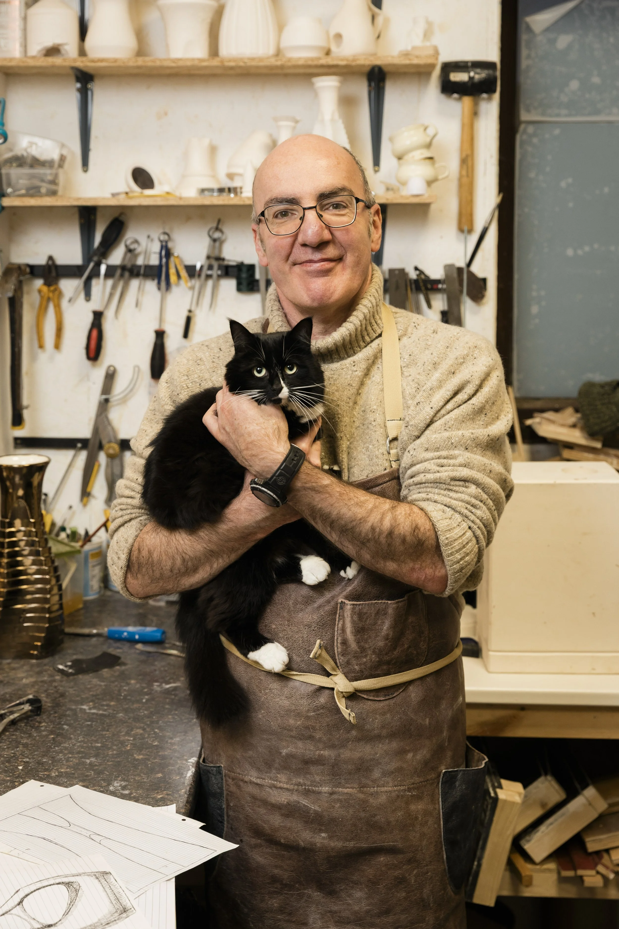 Arra Fletcher in his studio with his cat.
