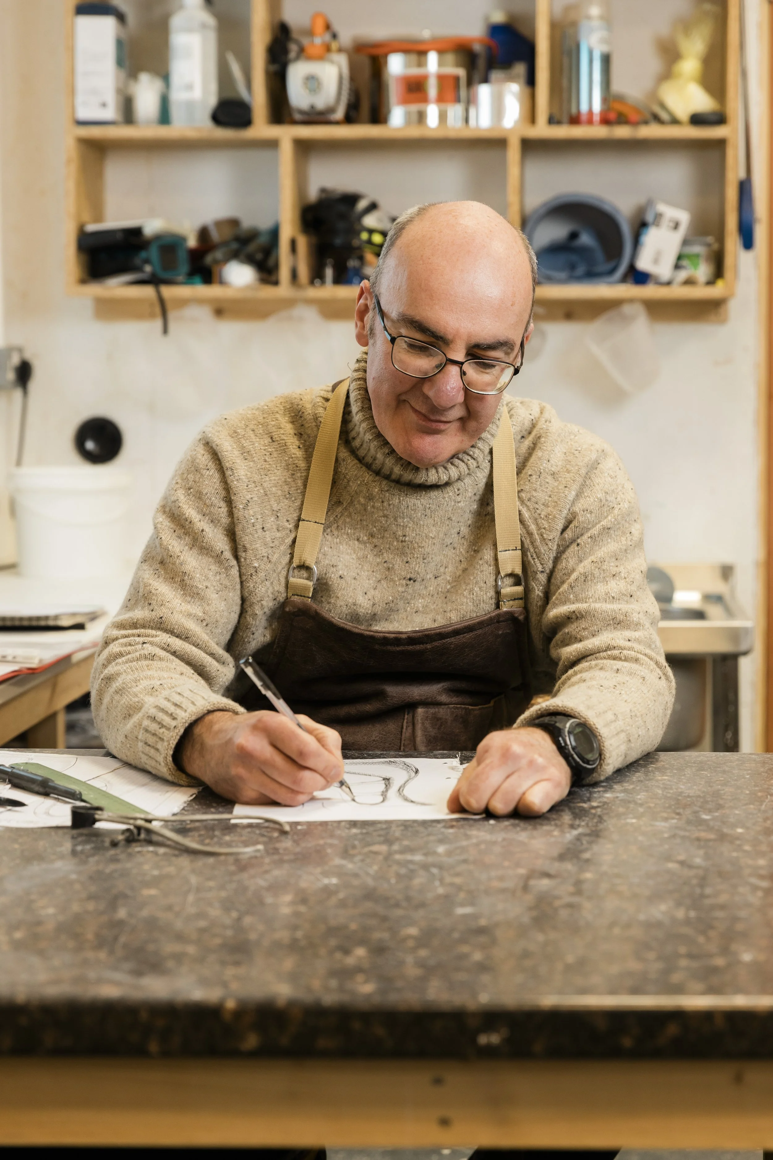 Scottish ceramics designer & maker, Arra Fletcher, drawing in his studio.