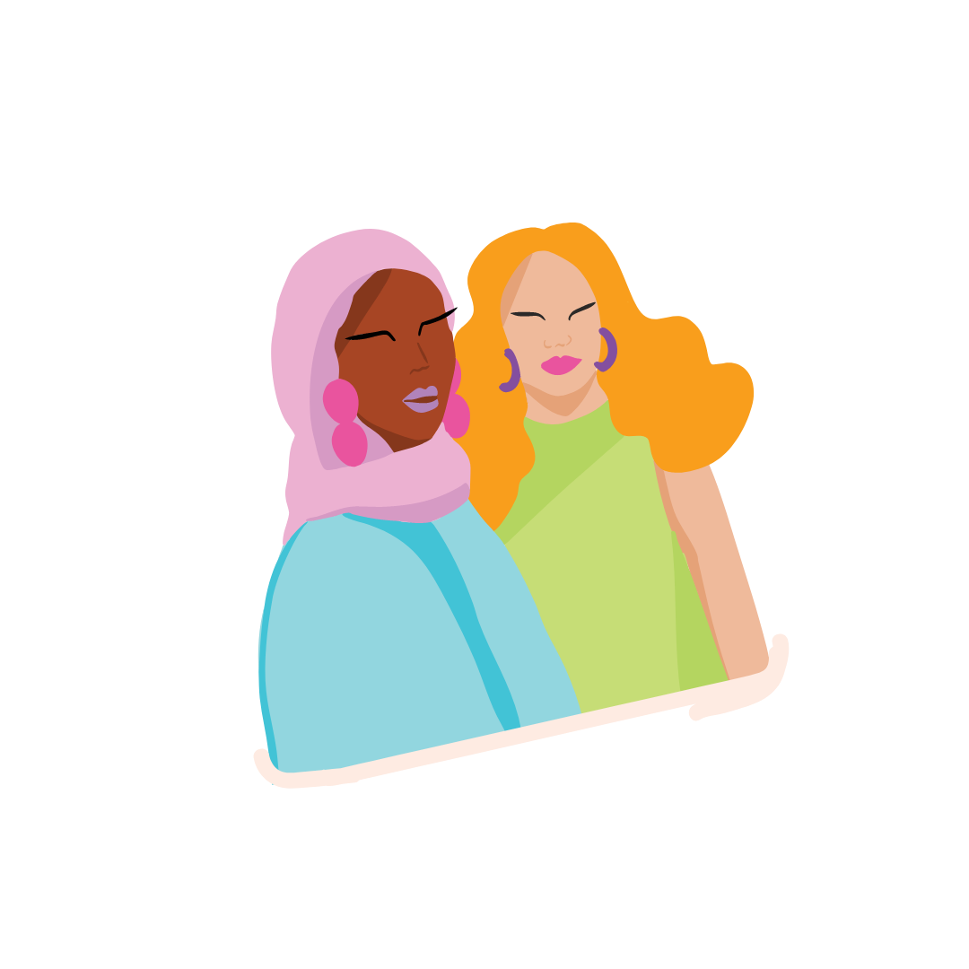 Two women with colorful clothing and accessories smiling, sitting together indoors.