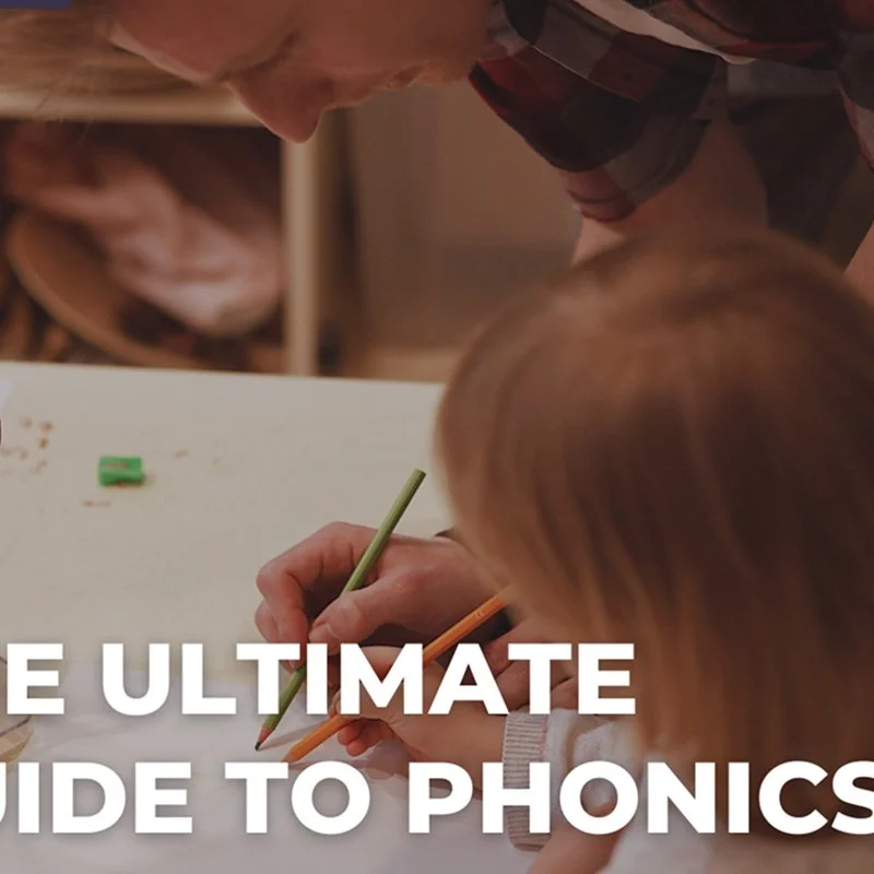 A person helping a child with schoolwork at a table, writing with colored pencils.