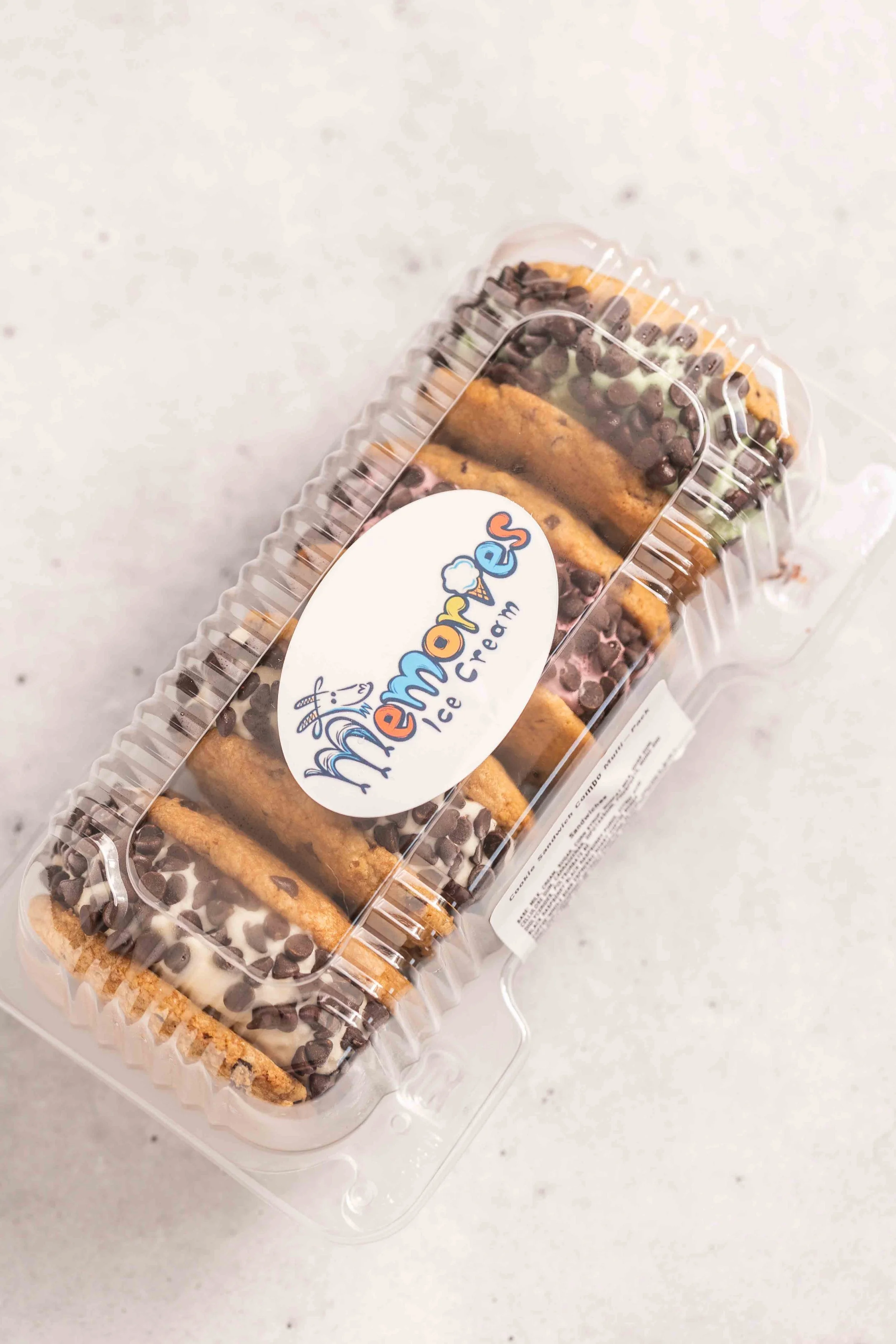 Container of assorted cookies from Mr. Remo's Ice Cream, featuring chocolate chip and chocolate-covered cookies.