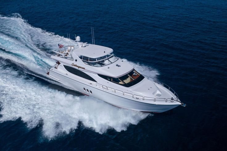 White yacht moving through the ocean creating a wake