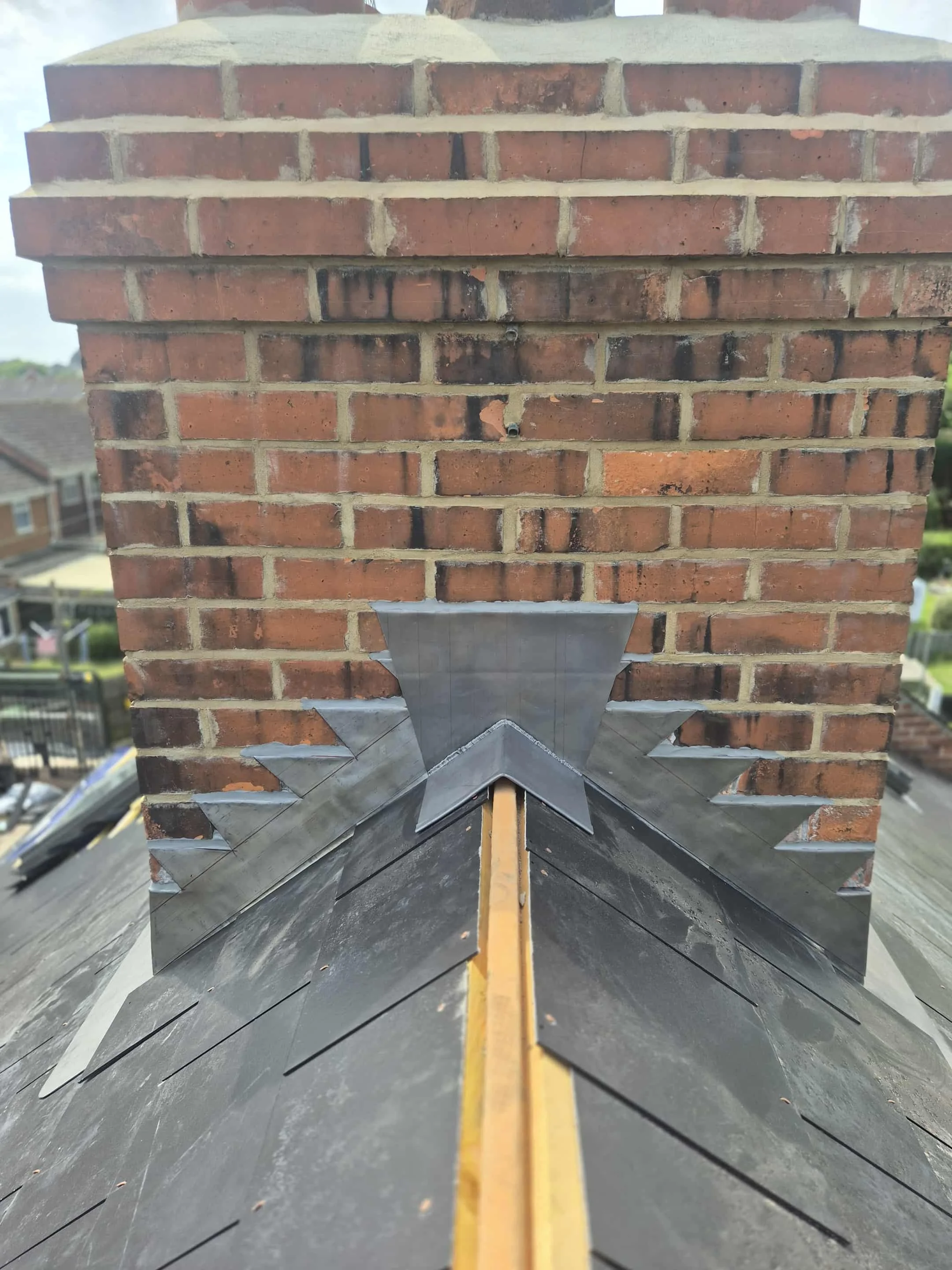 New lead flashing and weatherproofing around chimney stack, completed by Apex Roofing & Leadwork
