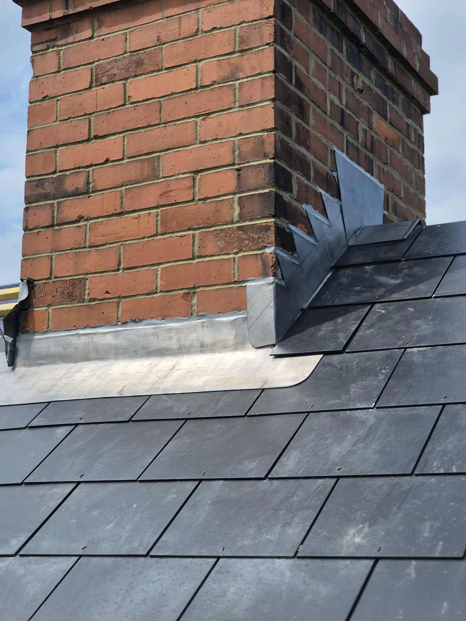 Apex Roofing & Leadwork installing new lead flashing around a chimney stack