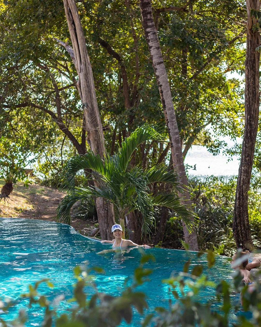 Poolside tranquility, anyone? 🌴

Float your worries away in our saltwater pool, surrounded by lush tropical greenery and lulled by the gentle sound of nearby ocean waves. Serenity, sunshine, and a splash of magic await.

Click the link in bio to boo