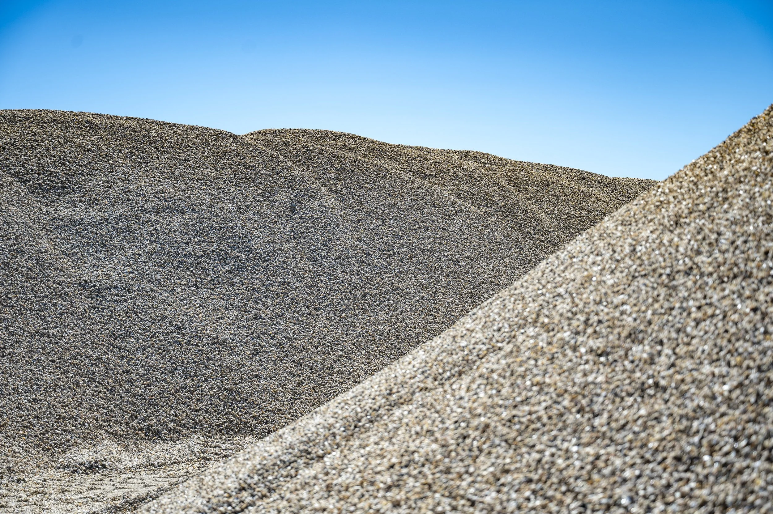 Close-up of sand dunes with blue sky in the background