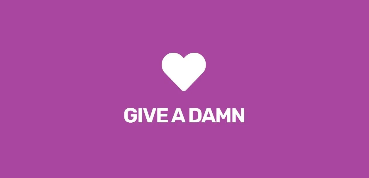 Purple background with a white heart icon and the text 'GIVE A DAMN' underneath. We are passionate about HR and making it work for our clients. 