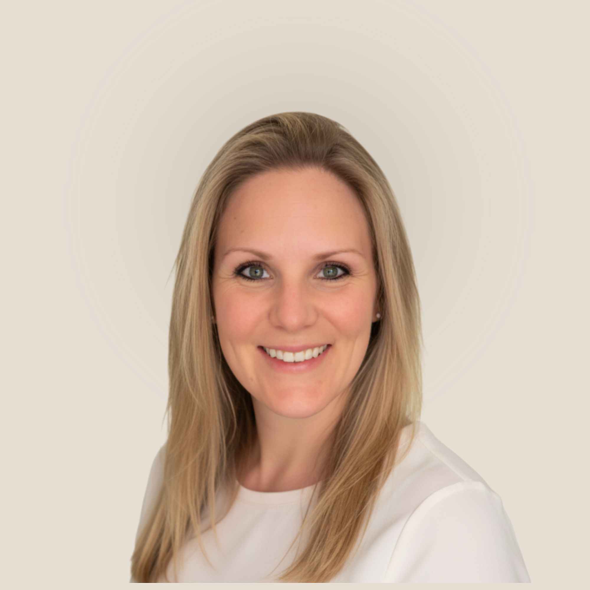 Close-up of a smiling woman with long blonde hair, blue eyes, and wearing a gray sweater against a white background. Her name is Lucie Kern