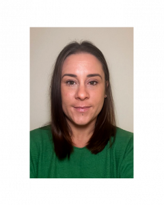 A woman with straight brown hair wearing a green top and small earrings, standing against a plain light-colored background. Her name is Rosie Bunnage