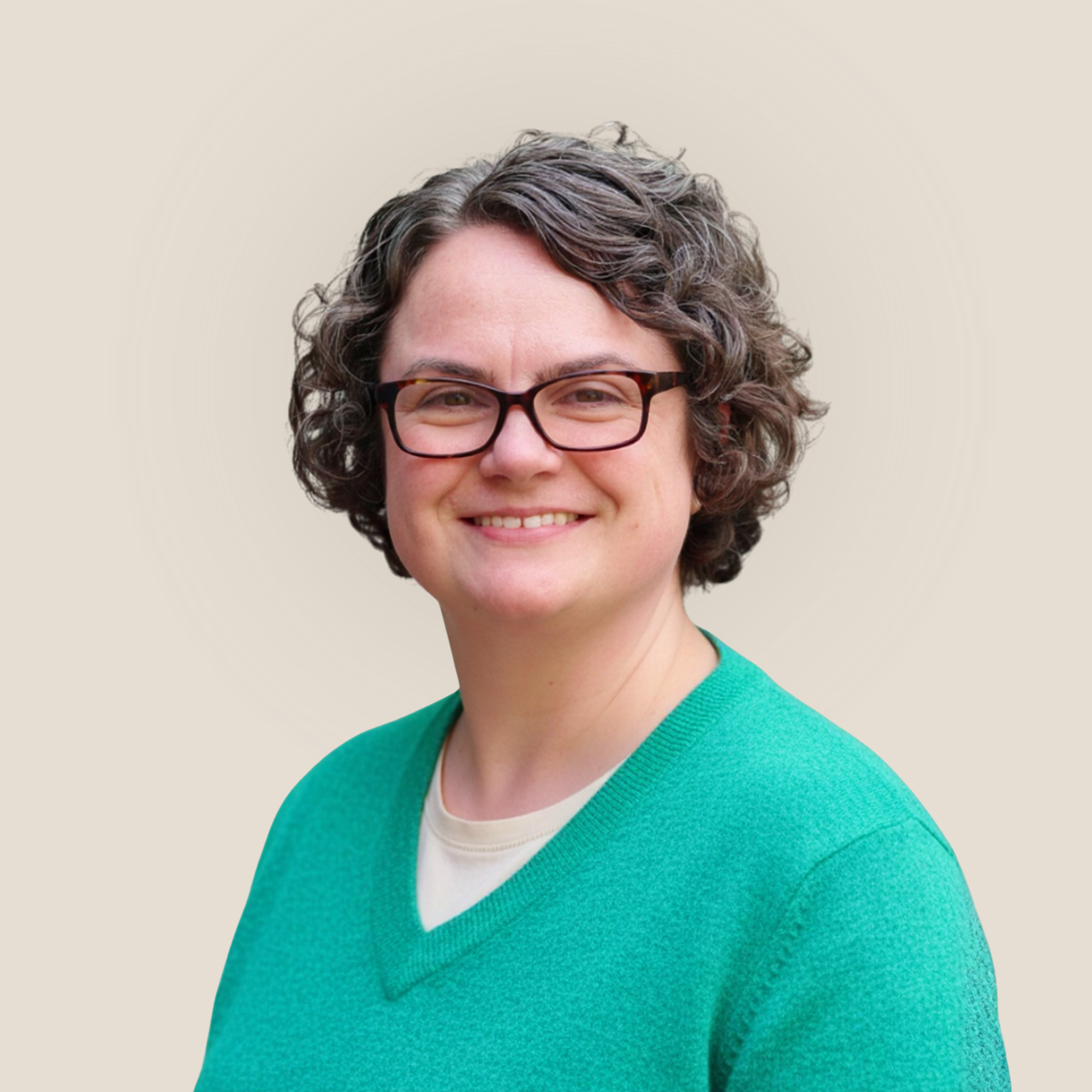 A woman with short, curly gray hair wearing glasses and a white sweater with black animal print, smiling at the camera. Her name is Michelle Potthurst