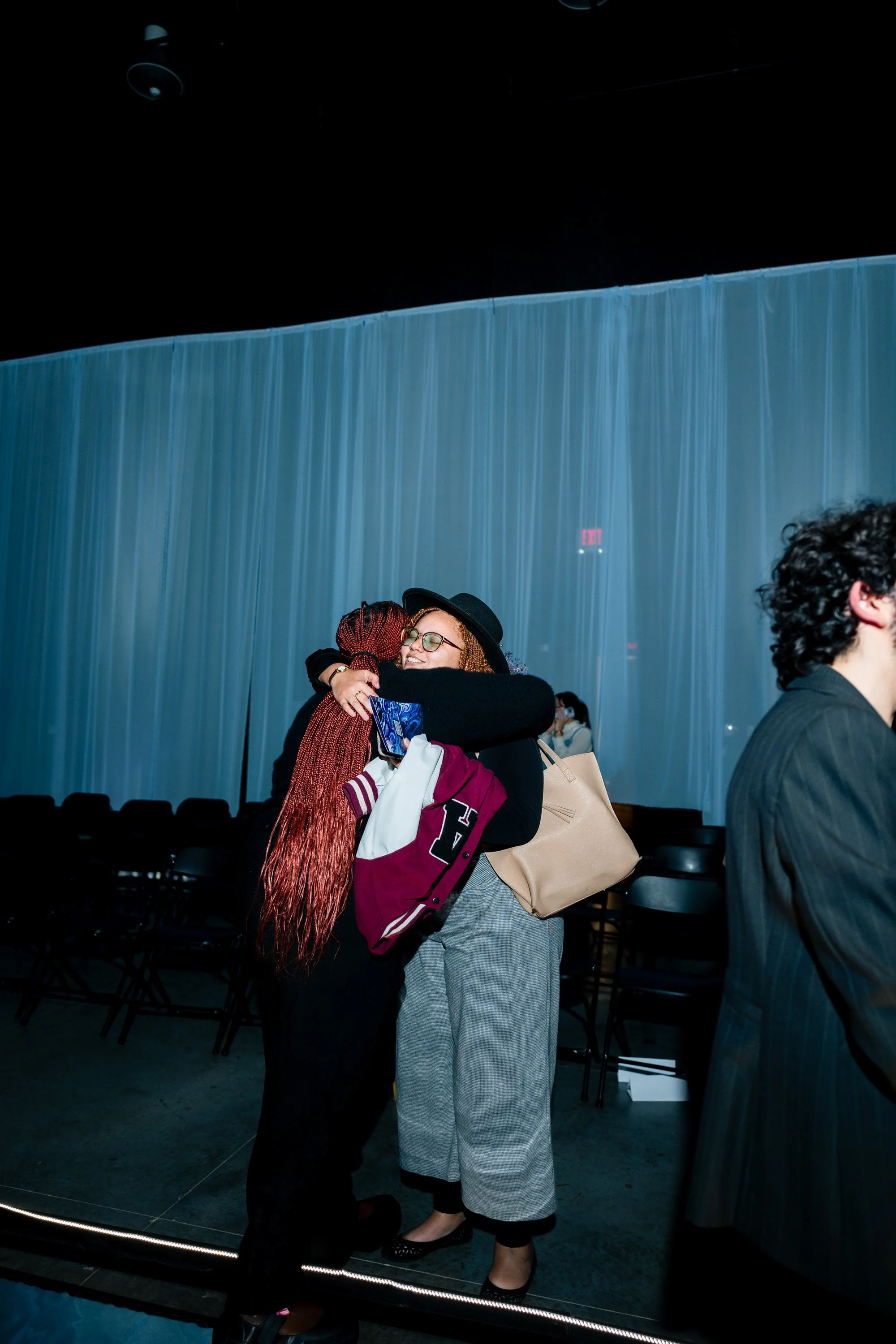 Genesis member and attendee hugging after the show