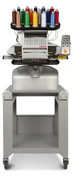 Sewing embroidery machine with multiple spools of colorful thread on top.