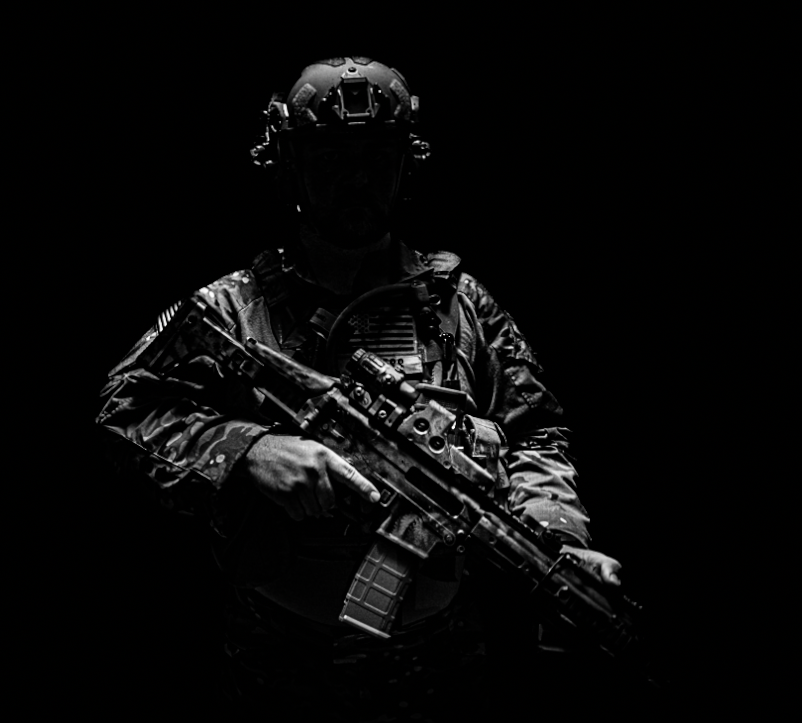 A silhouette of a soldier in military gear holding a rifle, against a dark background.