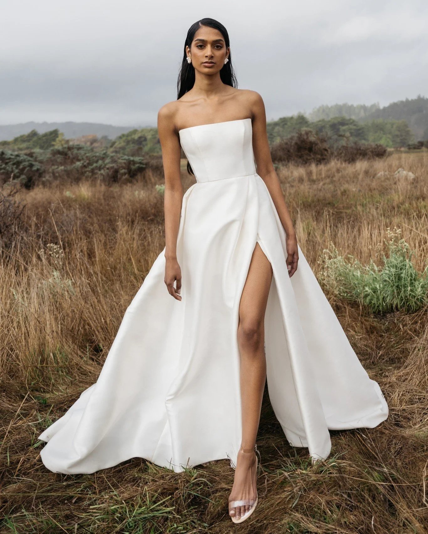 The Jenny Yoo &ldquo;Catherine&rdquo; gown is an effortless nod to old Hollywood. Made in Mikado, the straight neckline and sculpted bodice flow into a full ball skirt, complete with a dramatic slit.

She&rsquo;s timeless, confident, and made for a b