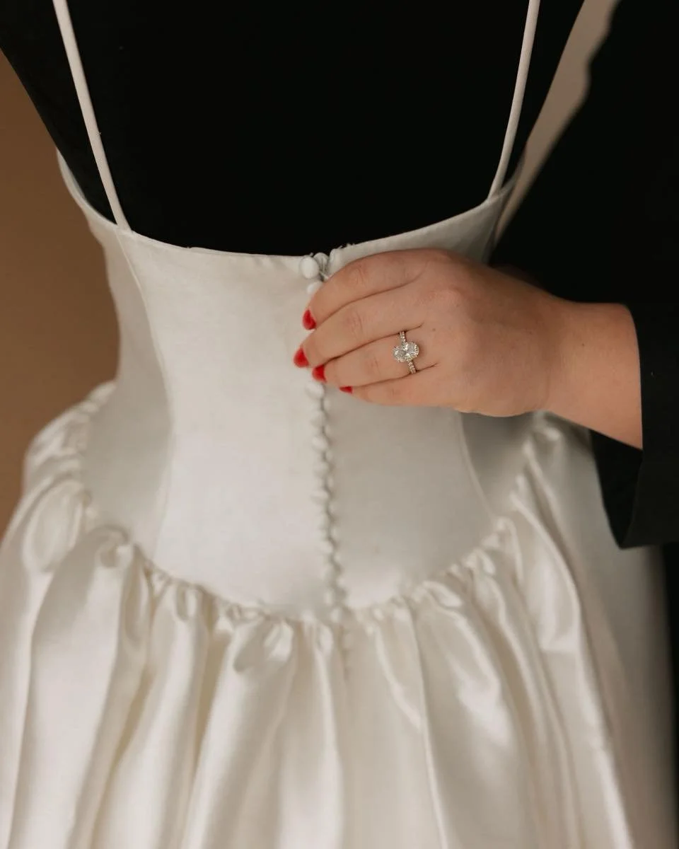 Every detail tells a story 🤍 The delicate buttons, the structured bodice, the soft satin skirt &mdash; some dresses just speak for themselves. ✨

#ambridal #ambridaltn #2026bride #2027bride #bridalgown #bridetobe #weddingdress #bridalboutique #weddi