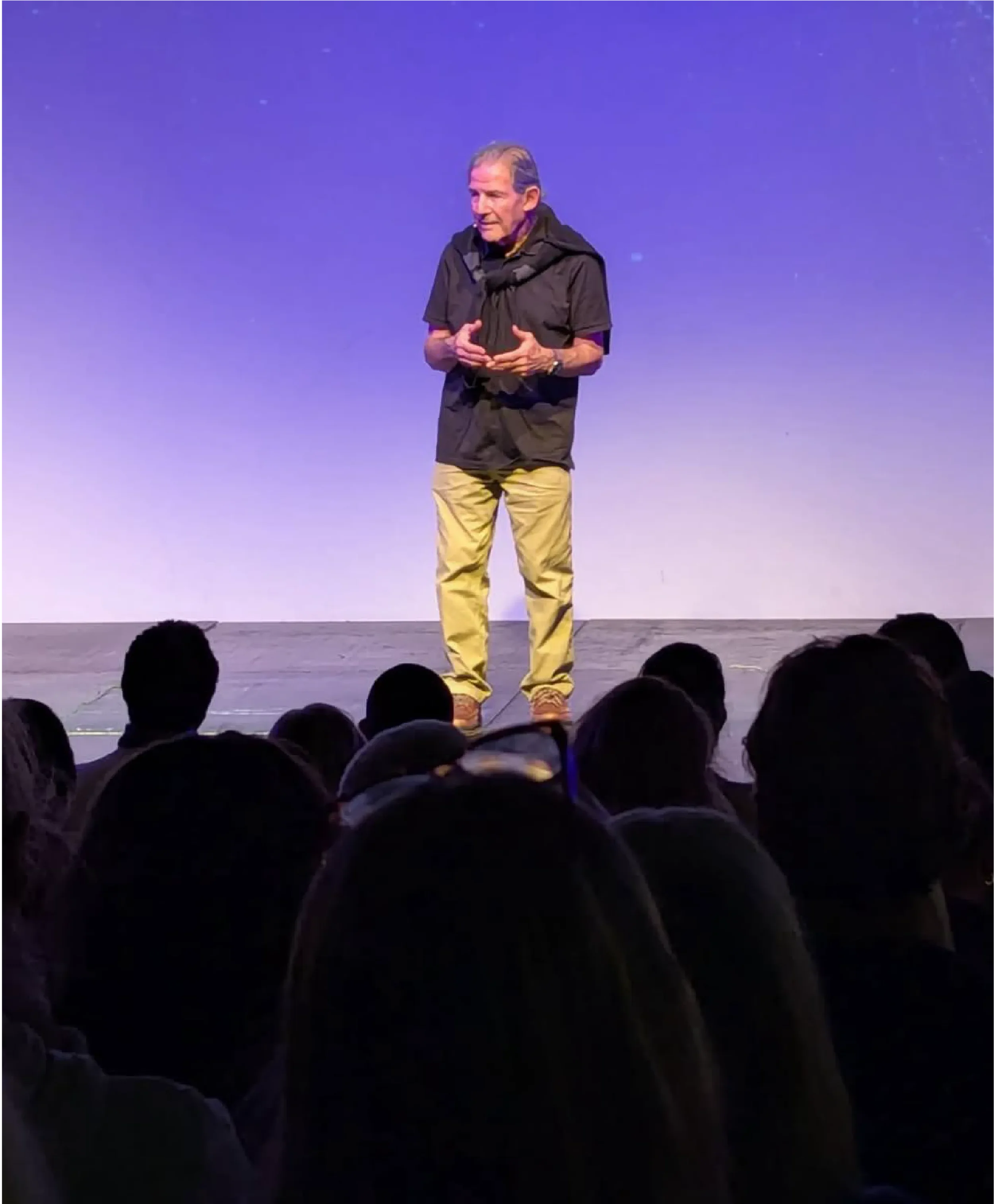 Gary Zukav, author and co-founder of Seat of the Soul Institute, speaking on stage to an audience, sharing teachings on spiritual growth and authentic power.