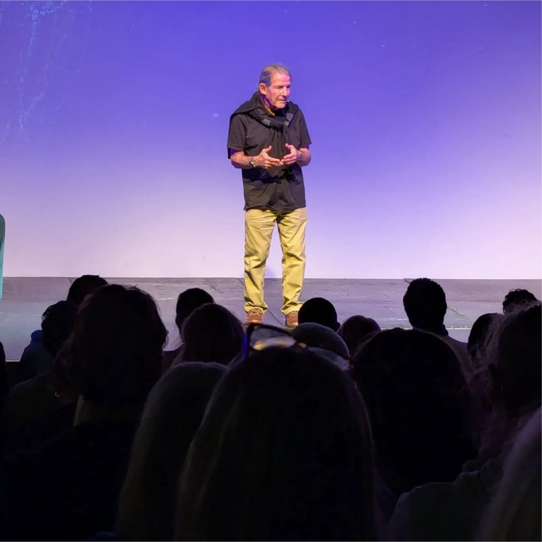 Gary Zukav speaking on stage to an audience, sharing teachings on spiritual growth and authentic power, representing Universal Human Foundation's educational outreach and events.