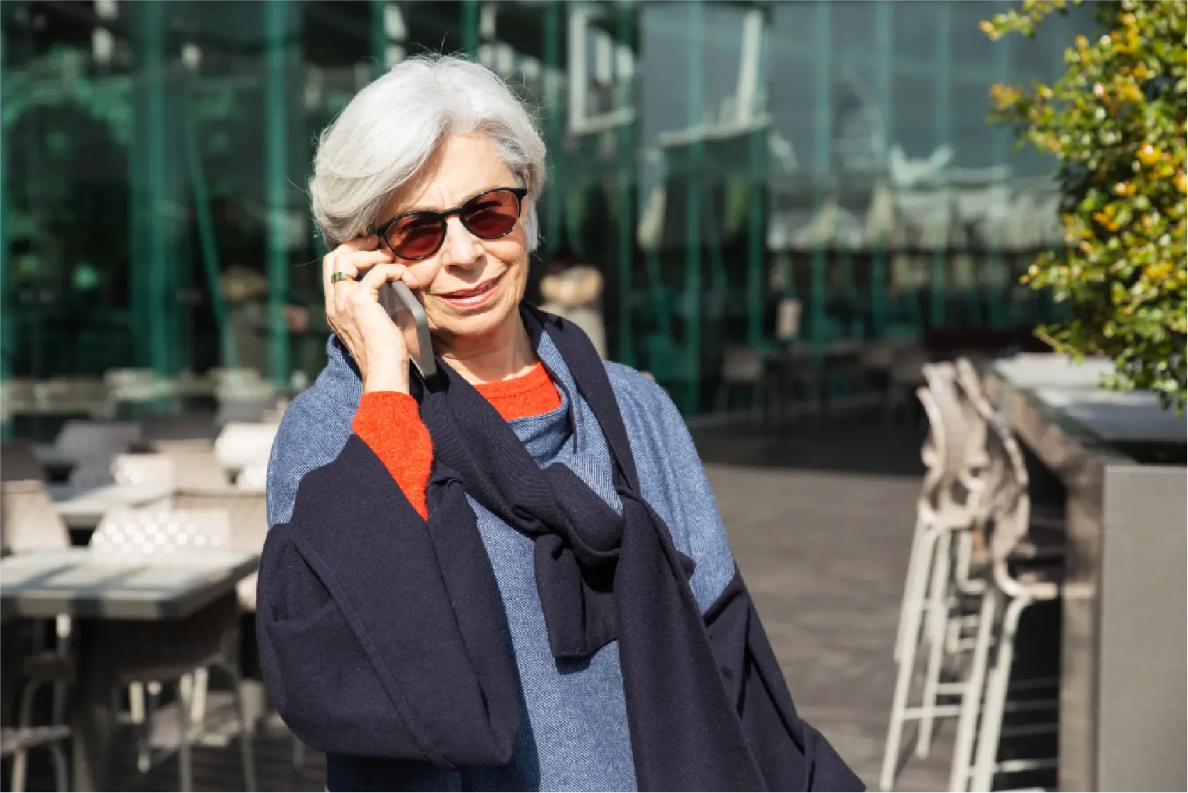 Senior woman on phone outdoors, smiling — Universal Human Foundation's emotional wellbeing support for Baby Boomers.