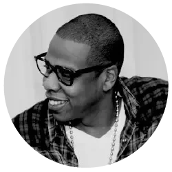 Black-and-white portrait of Jay-Z wearing glasses and a plaid shirt, featured as an endorser of Gary Zukav's book The Seat of the Soul.