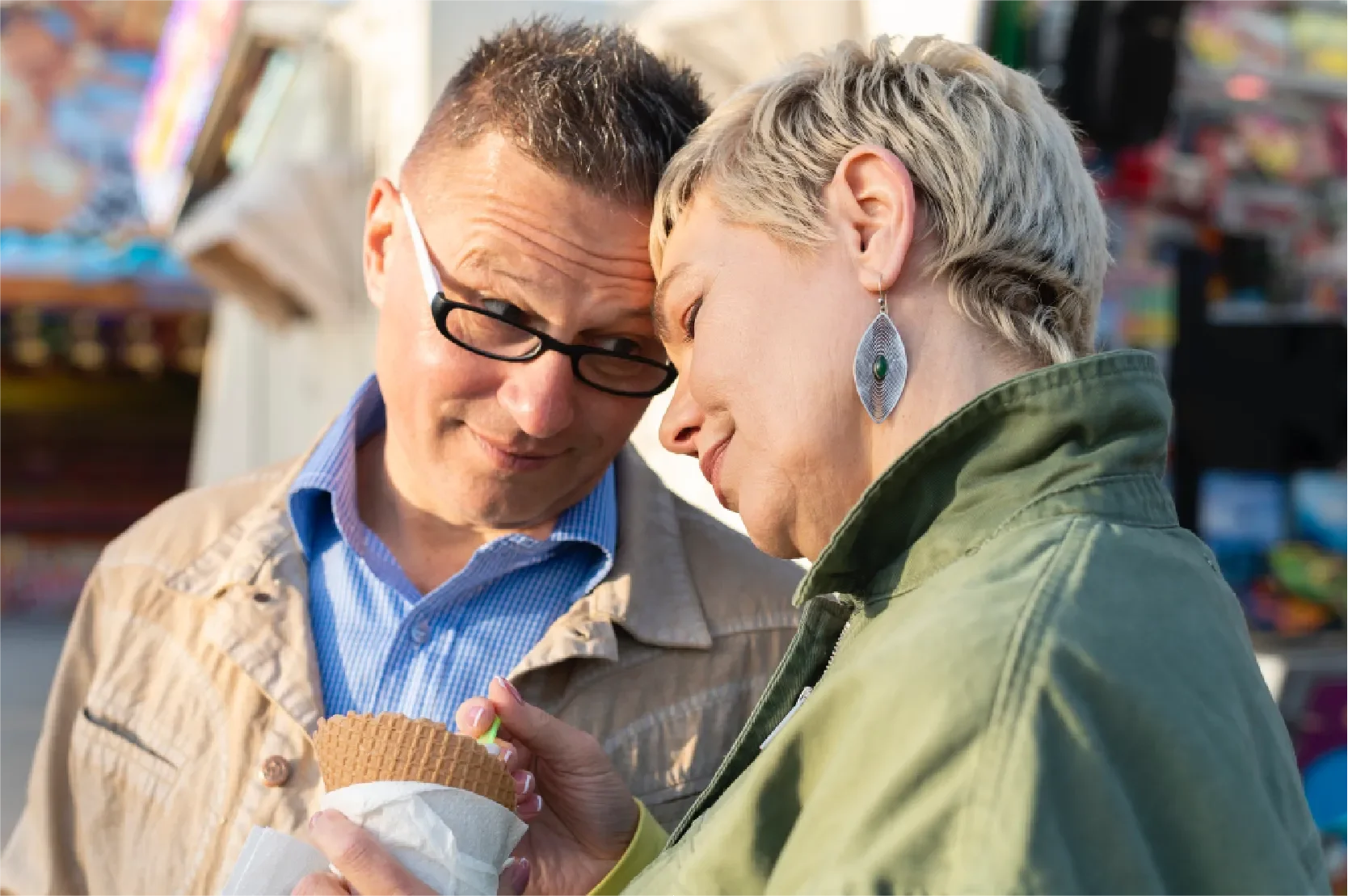 Middle-aged Gen X couple sharing a tender moment outdoors, foreheads gently touching, representing Universal Human Foundation's support for balancing responsibility, identity, and emotional health.