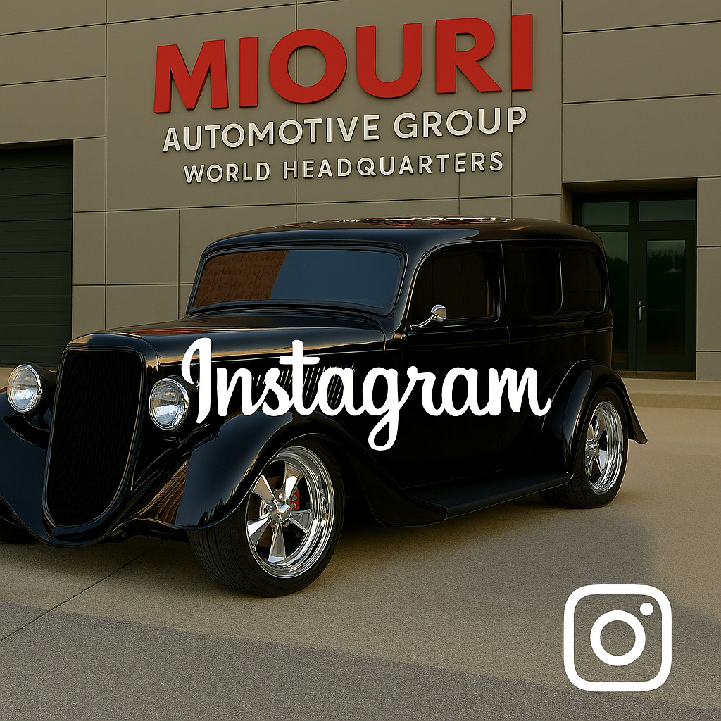 A vintage black car parked in front of a building with a sign that reads 'Miori Automotive Group World Headquarters.' The word 'Instagram' is overlaid on the image.
