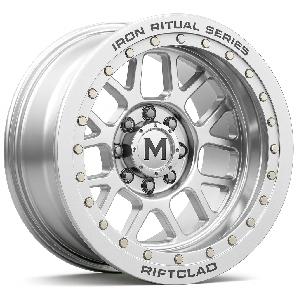 A silver off-road vehicle wheel rim with the text 'Iron Ritual Series' and 'Riftclad' on the outer edge.