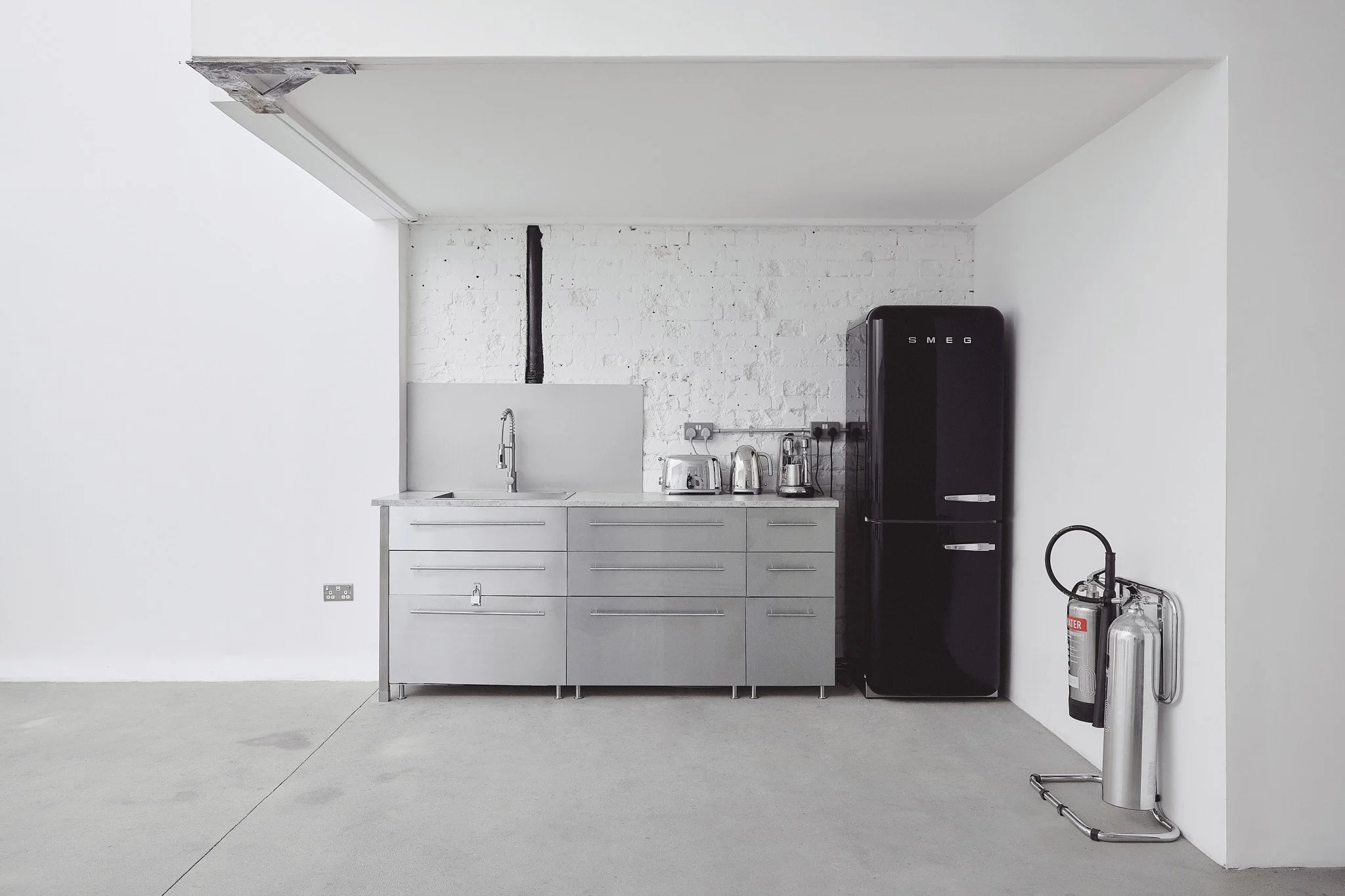 

Minimalist steel kitchen in east London studio — sleek industrial design ideal for food and lifestyle shoots
