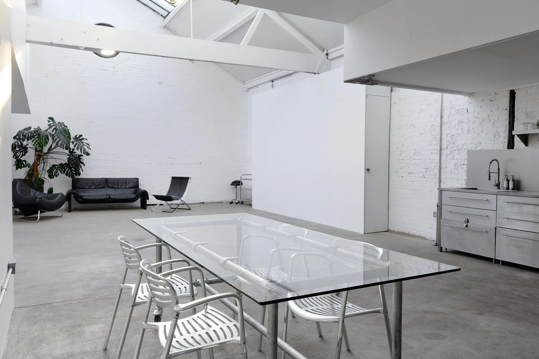 East London skylight loft studio flooded with natural light, featuring industrial minimalist interiors