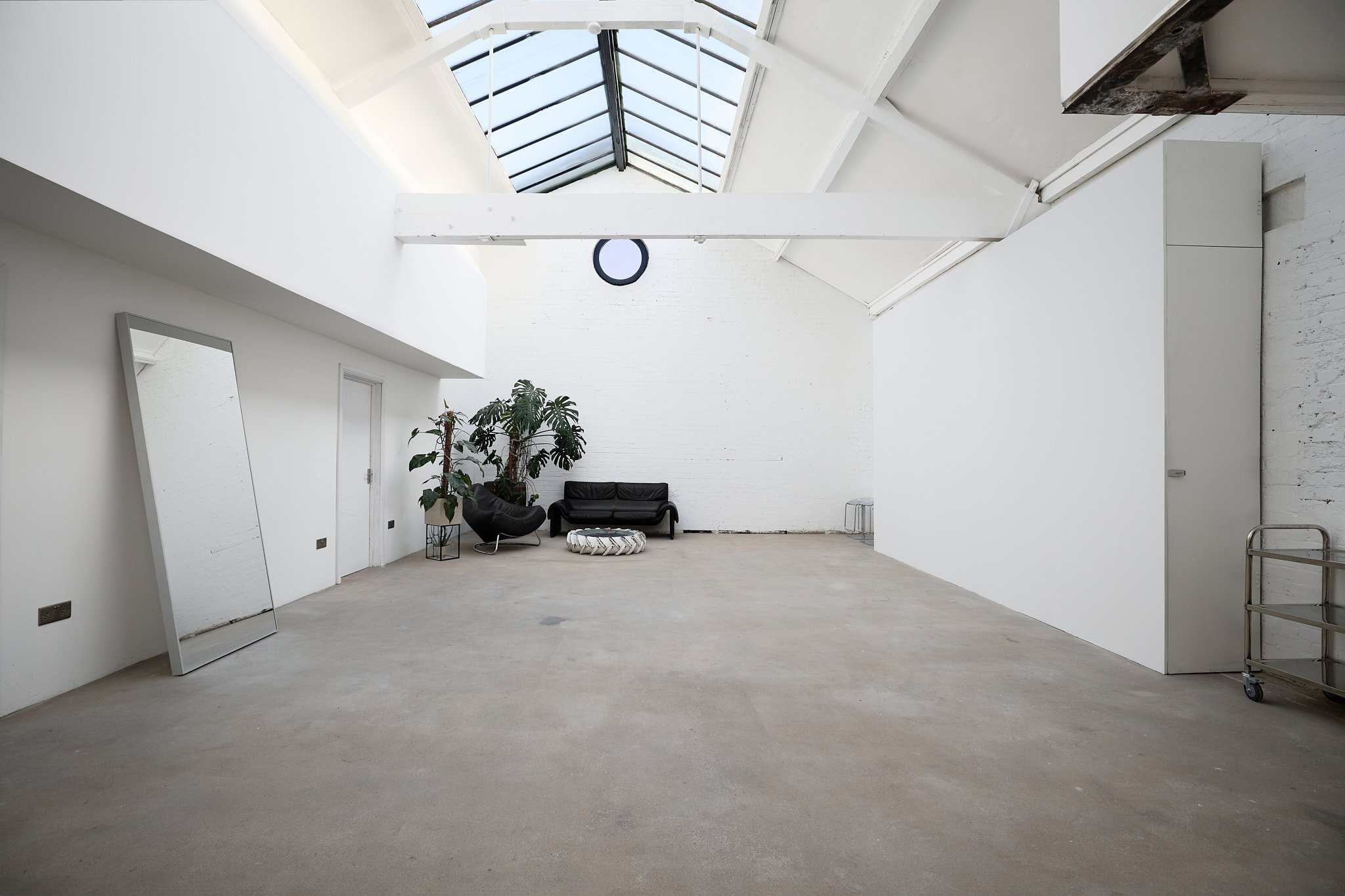 Hackney loft studio in London with large skylight, white brick walls and natural light — available for hire
