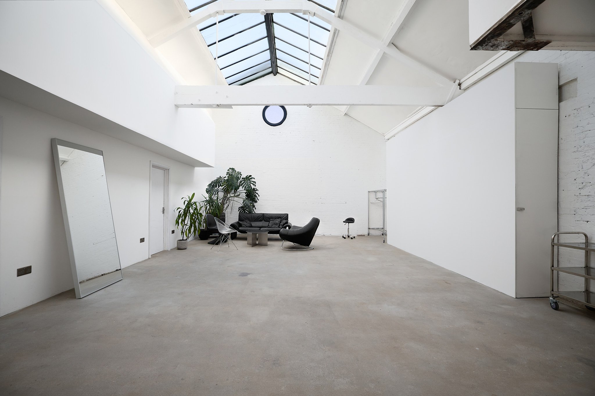Hackney loft studio in London with large skylight, white brick walls and natural light — available for hire