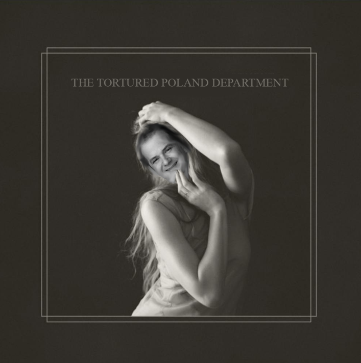 Black and white photo of a young woman with long hair, smiling and touching her head with one hand while the other hand rests on her chin, with the text 'The Tortured Poland Department' above her. She is framed within a minimalist border.