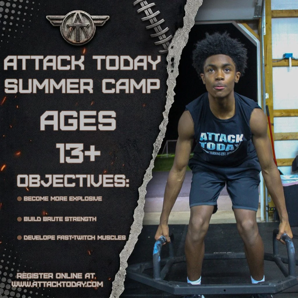 A young man participating in a workout at Attack Today Summer Camp. He is wearing a black tank top with the camp's logo and is standing on a training platform with a tire, in an indoor gym setting.