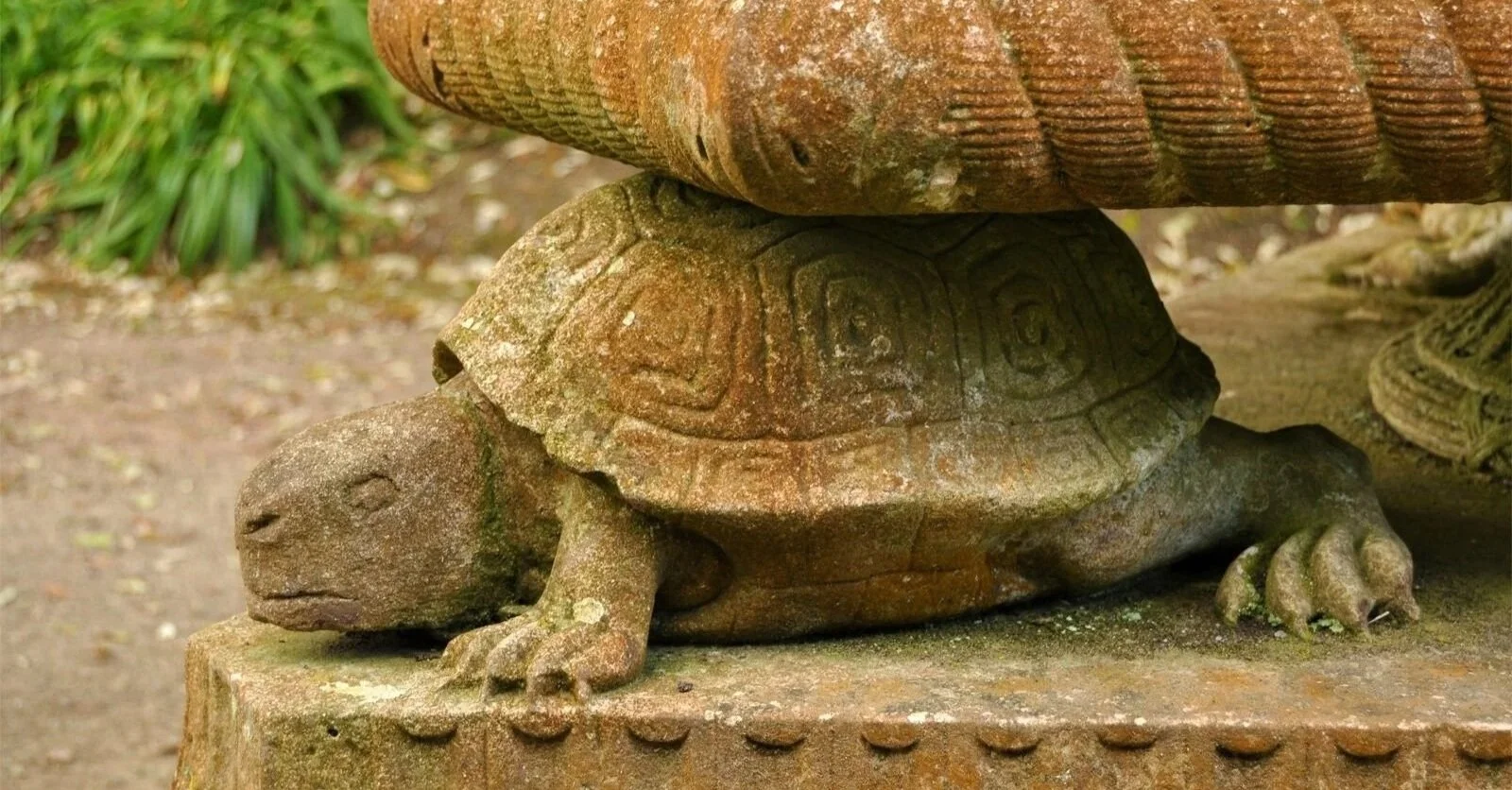 Tortoise base of Coade stone statue erected  by George Edgcumbe, 1st Earl, in memory of Timothy Brett c. 1793. The stone has weathered and is ochre in places, with lichen showing