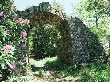 Colour photograph of archway in 2003 when arch was intact and path clear.