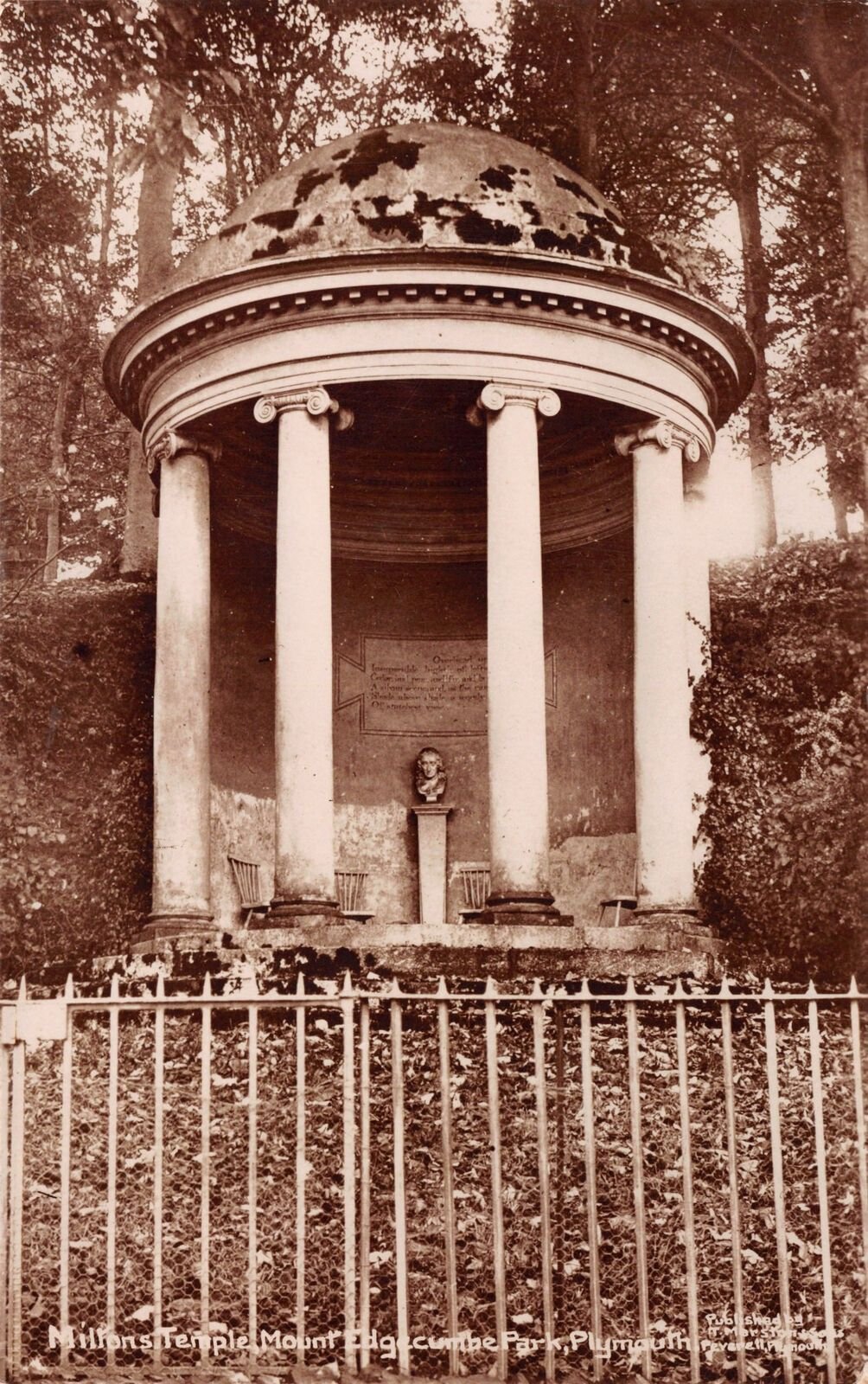 Sepia photograph of Milton's Temple c. 1900 when it still contained a statue of Milton. On the wall is a plaque with an excerpt from Milton's poem 'Paradise Lost'